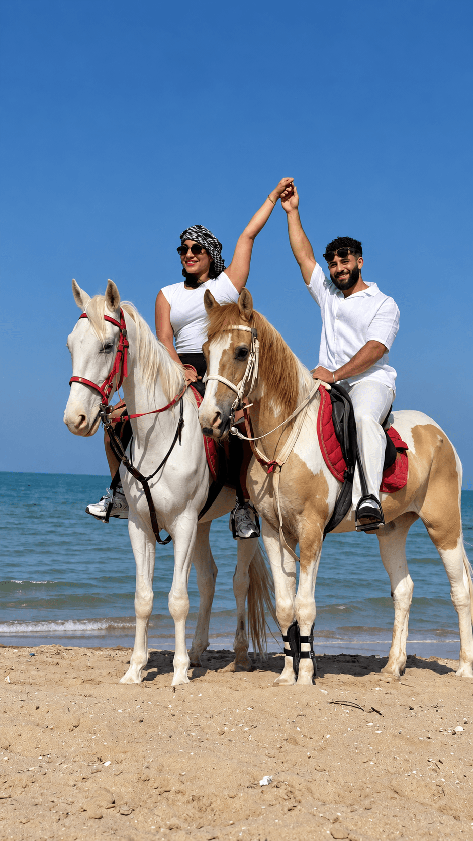 Two horseback riders from the owner-supplied seaside photo collection
