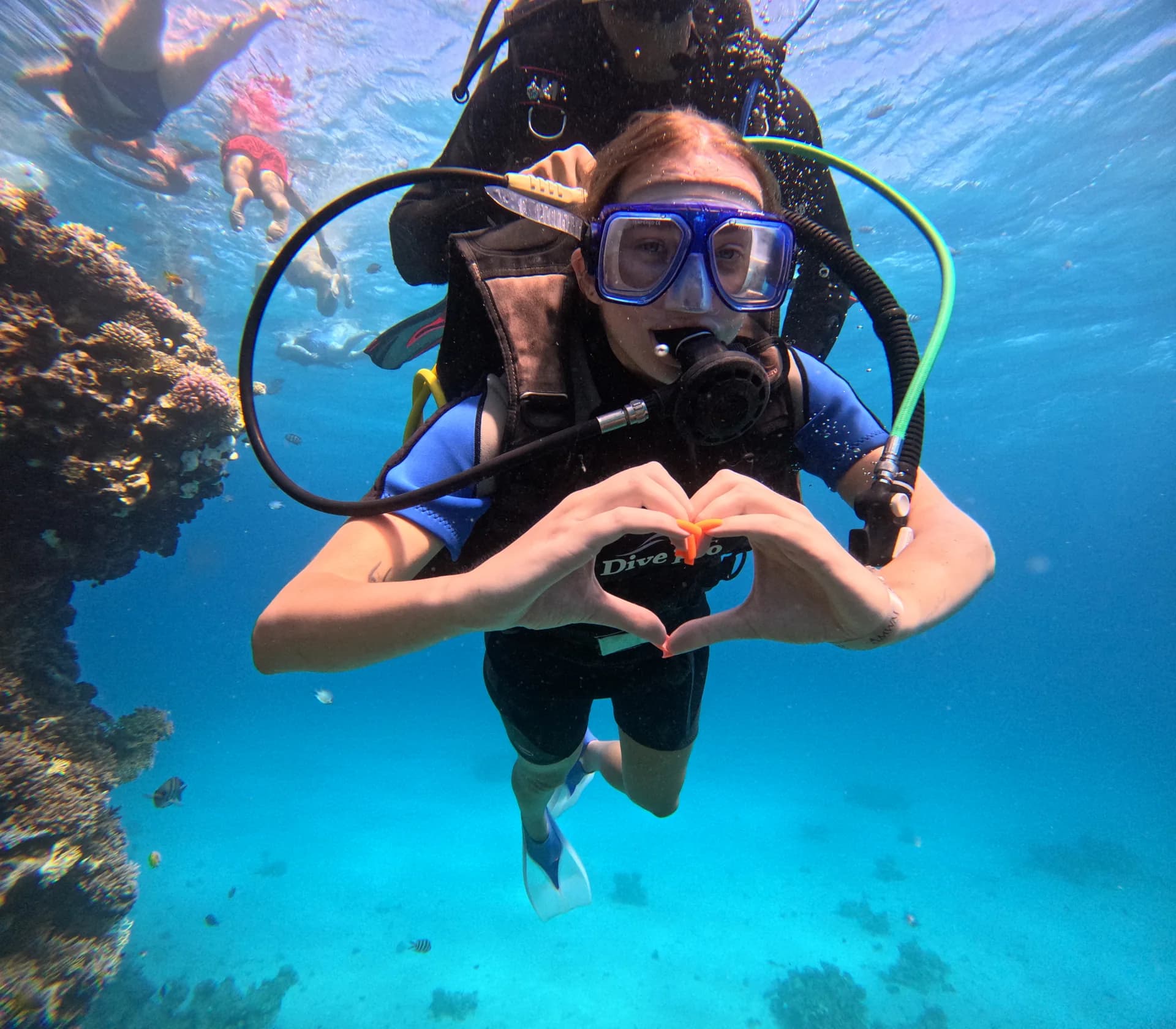 Scuba diver underwater using a regulator and diving mask